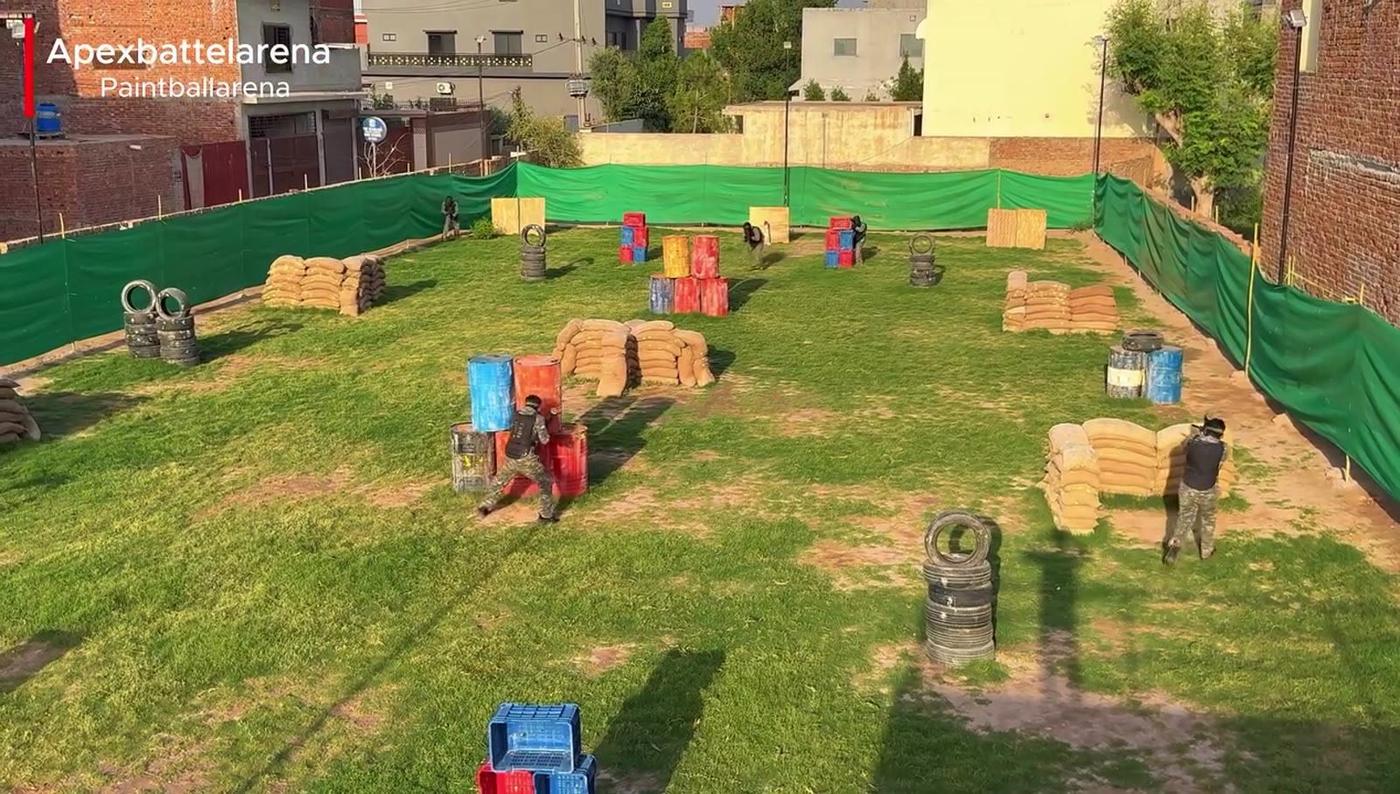 Wide view of the APEX arena field with sandbags, crates and tyre barricades